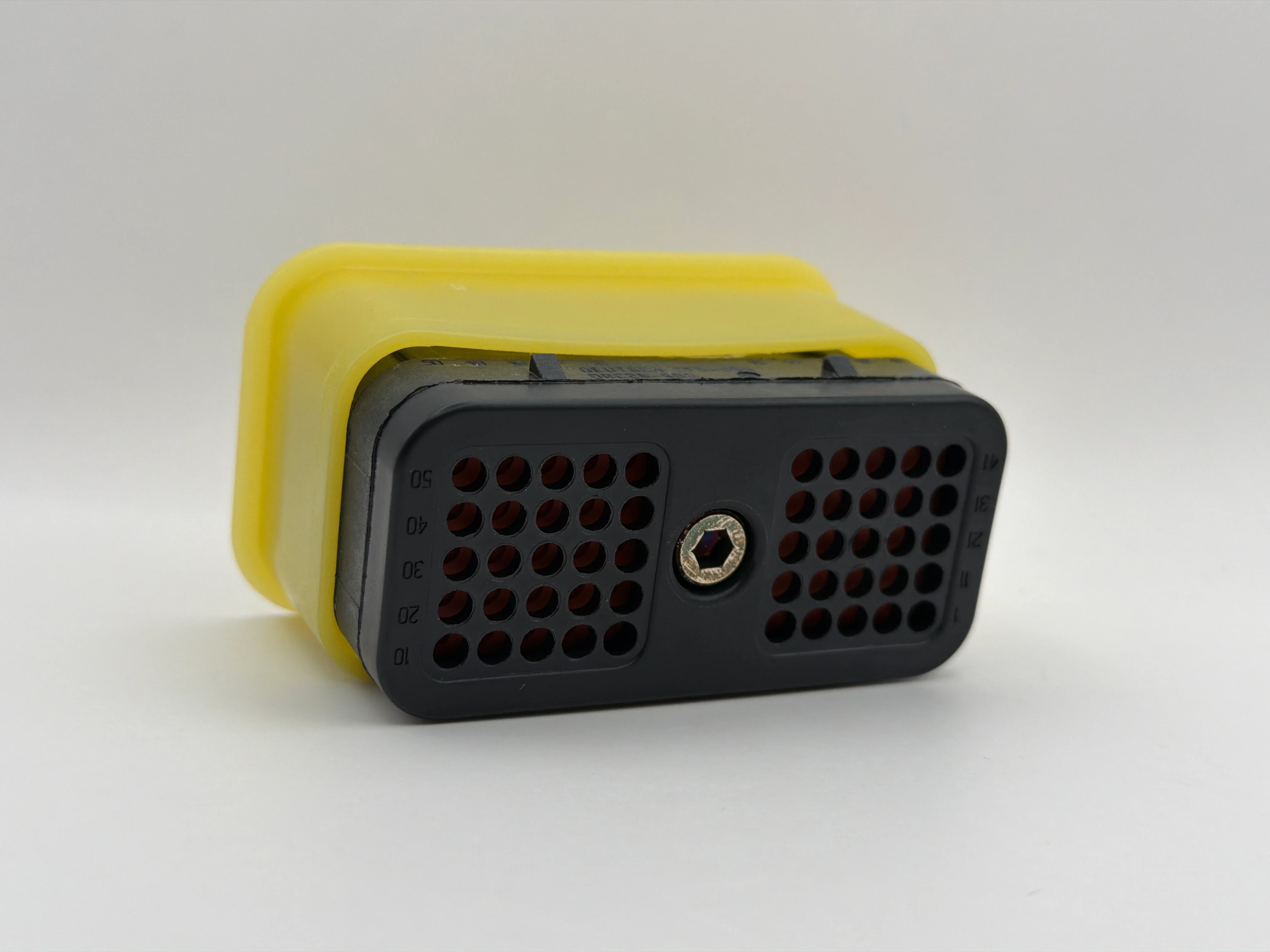 Deutsch DRC26-50S05 connector, angled view of the mating face with a yellow rear cover