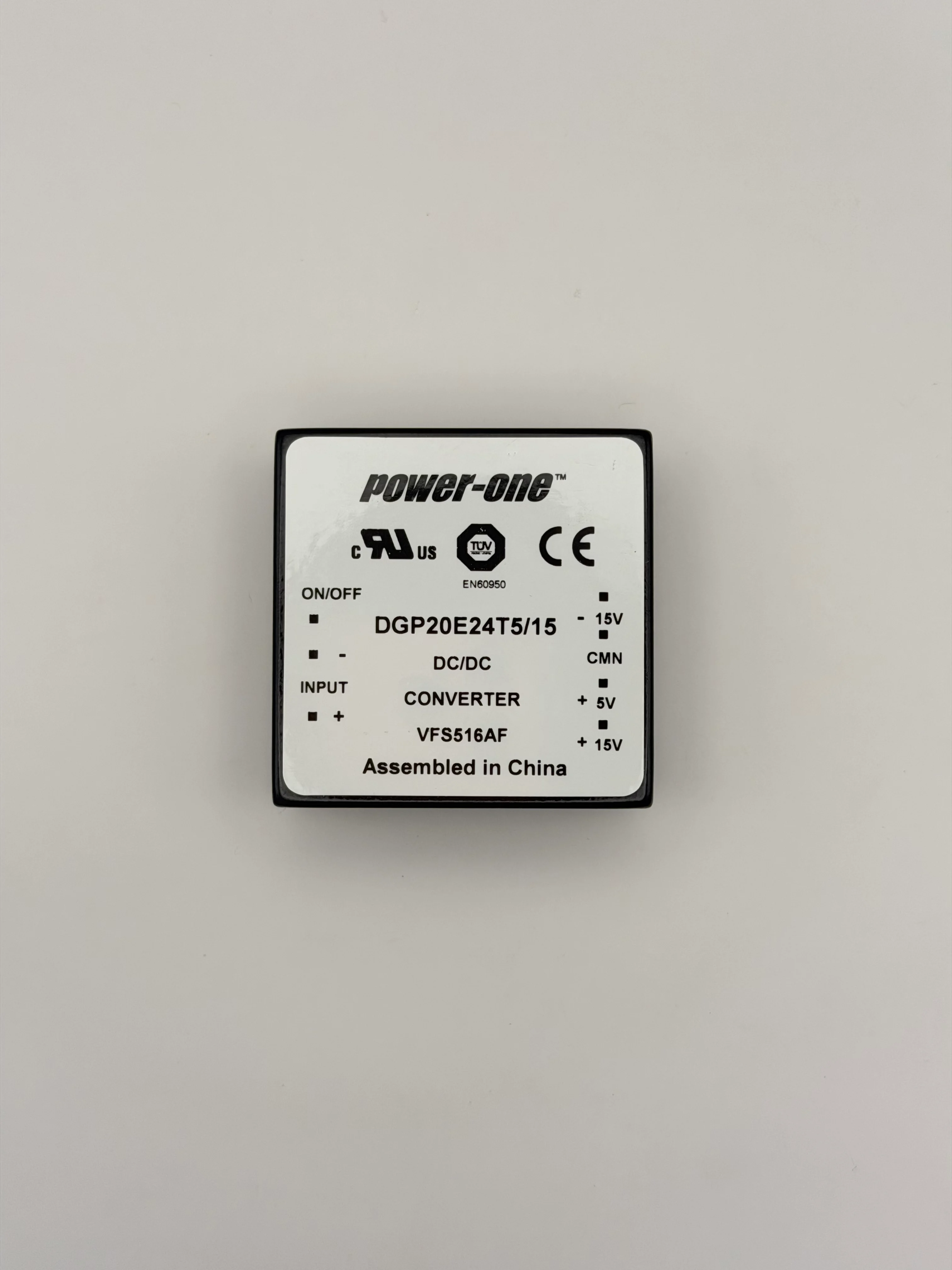 Top label of a Power-One DGP20E24T5/15 DC/DC converter showing the pinout markings