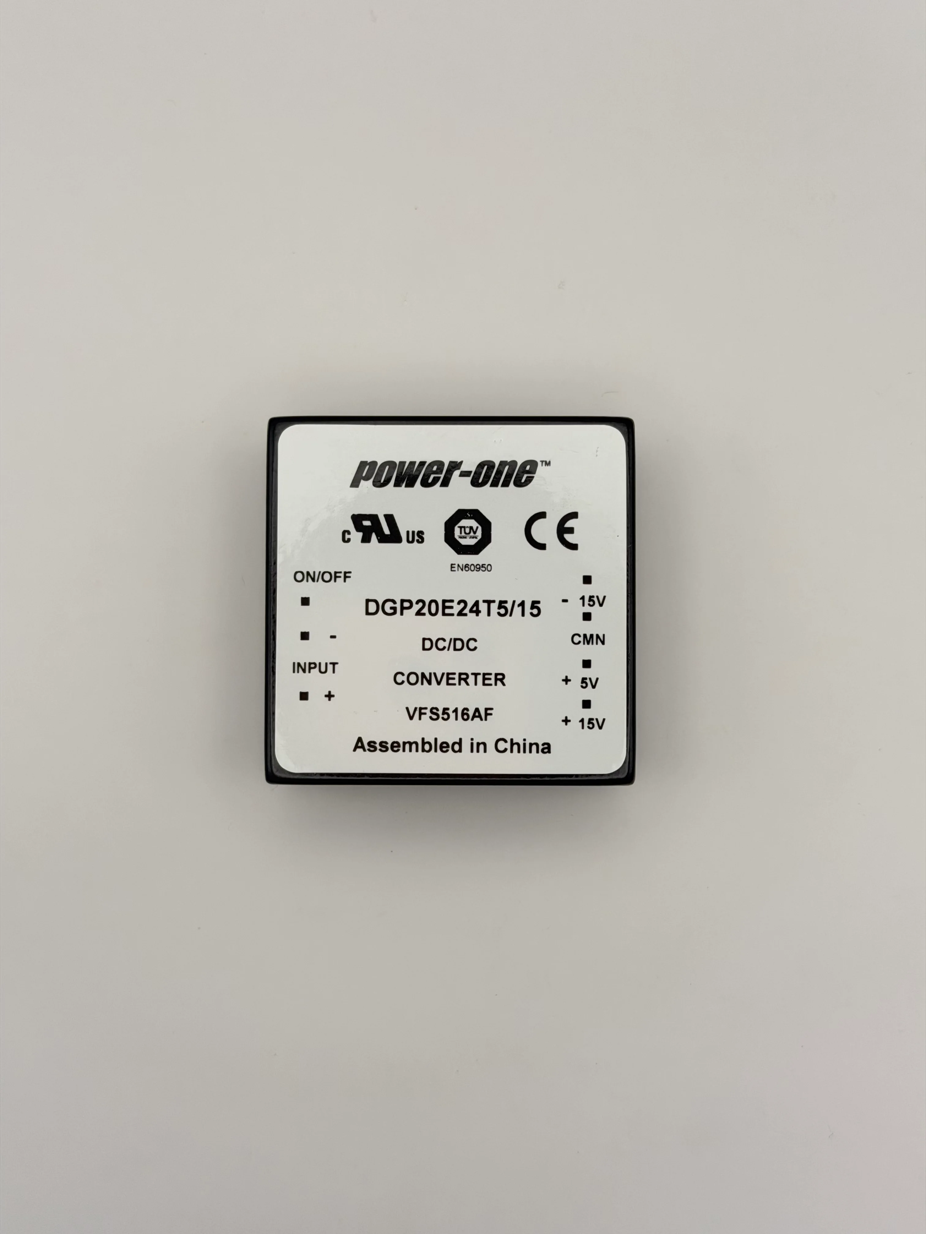 Top label of a Power-One DGP20E24T5/15 DC/DC converter showing the pinout markings